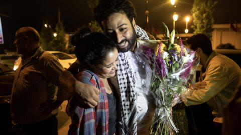 Moroccan journalist Omar Radi hugs his friend after leaving prison in Rabat on the evening of 29 July 2024.