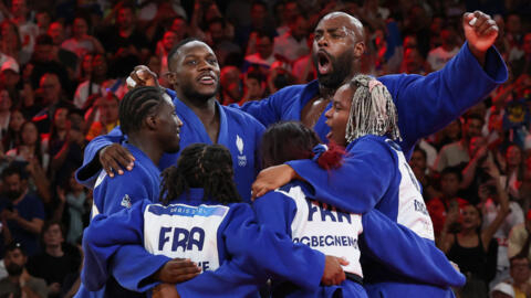 Team France celebrates after winning the judo mixed team gold medal bout between Japan and France at the Paris 2024 Olympic Games in the Champ-de-Mars Arena, in Paris on 3 August, 2024.