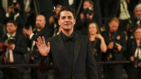 Xavier Dolan poses for photographers upon arrival for the premiere of the film 'Brother and Sister' at the 75th international film festival, Cannes, southern France, Friday, May 20, 2022. 