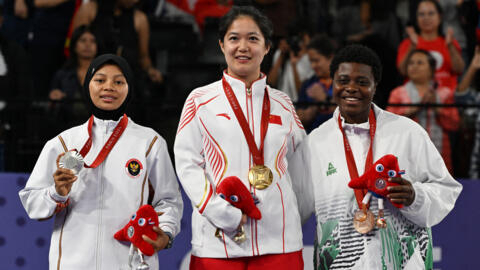 Paralympic gold medallist Xiao Zuxian of China, silver medallist Qonitah Ikhtiar Syakuroh of Indonesia and bronze medallist Mariam Eniola Bolaji of Nigeria celebrate on the podium after coming top in the women's singles in the badminton SL3 category, on 2 September 2024.