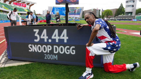 Snoop Dogg poses with scoreboard after running the 200m during the US Olympic Team Trials at Hayward Field in Eugene, Oregon, 23 June 2024.