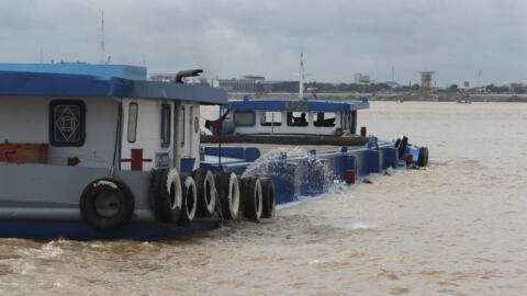 A river barge carries sand on the Mekong river outside Phnom Penh, Cambodia, Monday, Aug. 1, 2022. (AP Photo/Heng Sinith)
