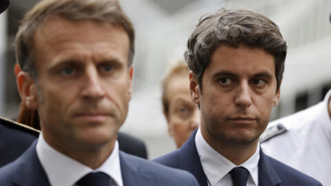 French Prime Minister Gabriel Attal watches French President Emmanuel Macron at a press conference in 2023. Both Macron and Attal's popularity ratings have slumped ahead of legislative elections taking place at the end of June and beginning of July 2024. 