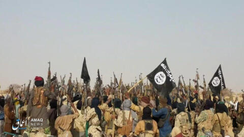 This handout picture released by the Islamic State's Aamaq News Agency shows a group of fighters celebrating. 