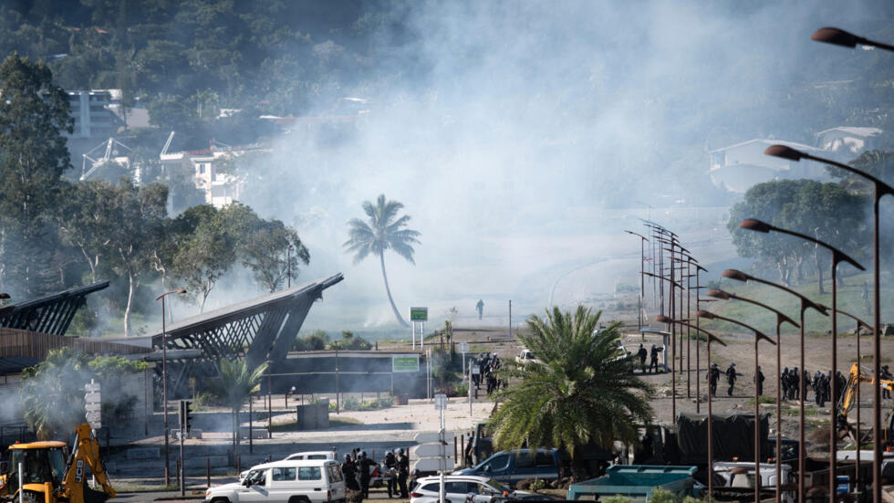 French gendarmes remove a roadblock in Dumbea, New Caledonia, amidst clashes with pro-independence protesters, 24 June 2024.