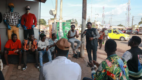 L’artiste camerounais Petit Malo (au centre), créateur du rythme musical Mbolé, un genre musical camerounais des quartiers populaires de Yaoundé, fait des gestes lors d’une improvisation après avoir rejoint un groupe d’amis dans le quartier Mvog-Ada à Yaoundé le 8 novembre 2022. (Image d'illustration).