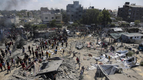 Palestinos inspeccionan los daños en un lugar afectado por un bombardeo israelí en Khan Younis, sur de la Franja de Gaza, sábado 13 de julio de 2024.