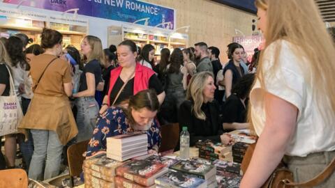 Romance author Kalypso Caldin signing books for fans at the Paris book fair, April 2024.