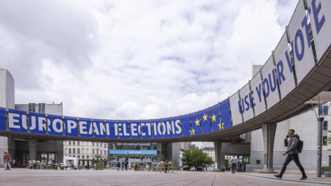 People walk outside the European Parliament prior to a debate with the lead candidates for the European Parliament elections in Brussels, Thursday, May 23, 2024. European elections will take place from June 6-9, 2024. (AP Photo/Geert Vanden Wijngaert)