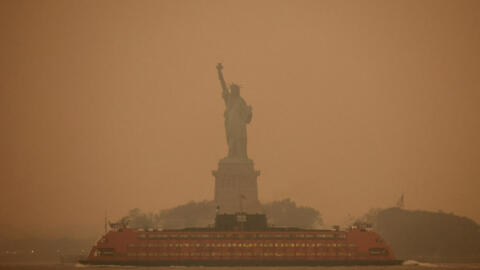 FILE PHOTO: The Statue of Liberty is covered in haze and smoke caused by wildfires in Canada, in New York, U.S., June 6, 2023. REUTERS/Amr Alfiky/File Photo