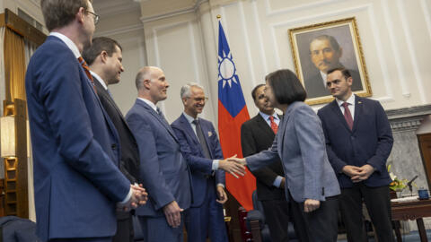 In this photo released by the Taiwan Presidential Office, Taiwan's President Tsai Ing-wen, second right, shakes hands with members of United States Congressmen as Rep. Mike Gallagher, the Republican c