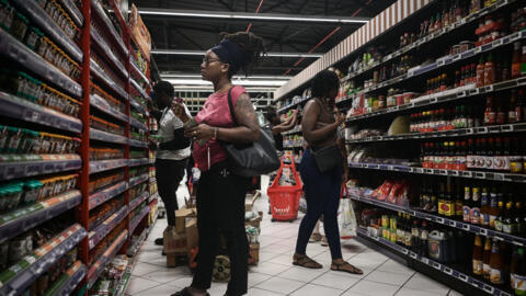 Shoppers browse at a supermarket in Fort-de-France, on the French Caribbean island of Martinique on 14 October, amid riots over rising prices.