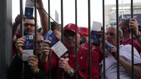 Liverpool fans show tickets and wait in front of the Stade de France prior the Champions League final soccer match between Liverpool and Real Madrid, in Saint Denis near Paris, on 28 May, 2022.