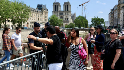 French gendarme prevent people from crossing the Ile de la Cite near Notre Dame Cathedral as the security perimeter for the opening ceremony is deployed ahead of the Paris 2024 Olympics and Paralympic