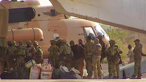 This undated photograph handed out by French military shows Russian mercenaries boarding a helicopter in northern Mali. 