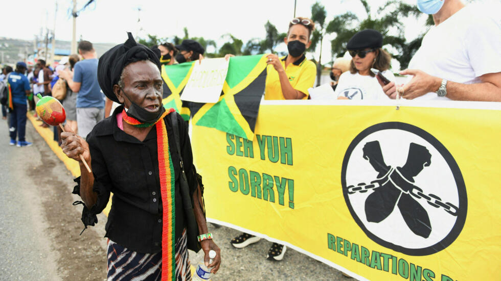 People calling for slavery reparations protesting outside the entrance of the British High Commission during the visit of the Duke and Duchess of Cambridge in Kingston, Jamaica on 22 March 2022.