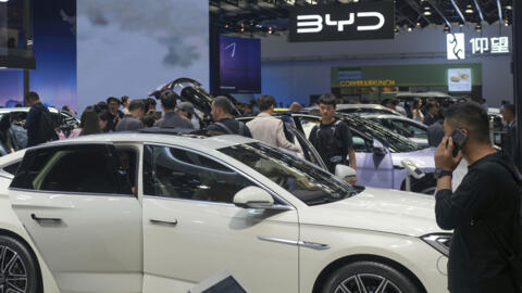 Visitors look at cars at the BYD booth during the China Auto Show in Beijing, China, Friday, 26 April, 2024.