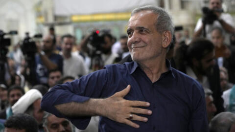 Iran's President-elect Masoud Pezeshkian greets his supporters in a meeting a day after the presidential election, at the shrine of the late revolutionary founder Ayatollah Khomeini, just outside Tehr
