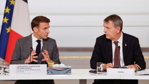 French President Emmanuel Macron speaks to Commissioner general of UNRWA Philippe Lazzarini at an international donor conference for civilians in Gaza.