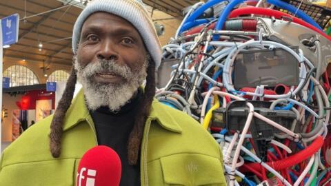 Artist and sculptor Malam, in front of his installation "Emergency Therapy" at the Also Known as Africa art and design fair in Paris, 17 October, 2024.