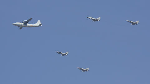 A Y-9 transport plane and J-10 fighter jets fly in formation during a parade commemorating the 70th anniversary of Japan's surrender during World War II in Beijing, Thursday, Sept. 3, 2015. The specta