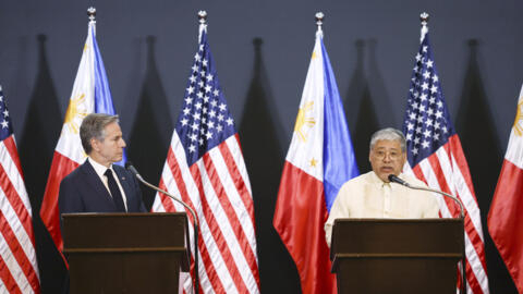 U.S. Secretary of State Antony Blinken, left, listens as Philippine Foreign Secretary Enrique Manalo speaks to the media during a joint press conference also with U.S. Defense Secretary Lloyd Austin a