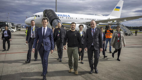 Ukrainian President Volodymyr Zelensky, centre, arrives at Zurich airport on Friday 14 June, 2024.