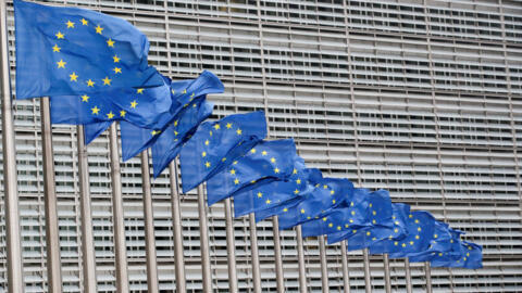 European Union flags flutter outside the EU Commission headquarters in Brussels, Belgium. 