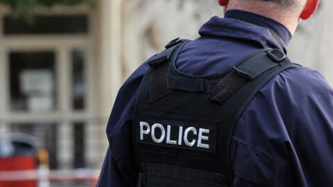 A French police officer outside the Gambetta high school in Arras, north-eastern France on October 16, 2023, three days after a teacher was killed and two other people were badly wounded in a knife attack.