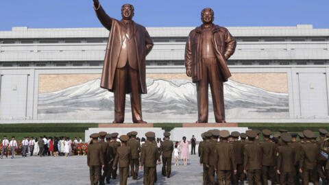 Pyongyang citizens pay respect to the statues of their late leaders Kim Il Sung, left, and Kim Jong Il on Mansu Hill on the occasion of the country's 76th founding anniversary in Pyongyang, North Kore