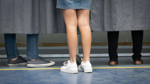 People vote in the first round of French parliamentary elections at a polling station in Noumea in New Caledonia, on 30 June 2024.