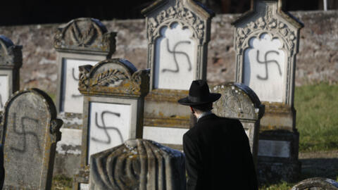 In this Dec. 4, 2019 file photo, Strasbourg chief Rabbi Harold Abraham Weill looks at vandalized tombs in the Jewish cemetery of Westhoffen, west of the city of Strasbourg, eastern France.