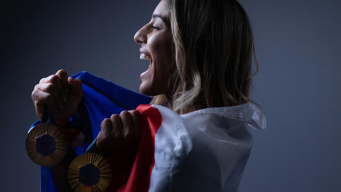 French judoka Shirine Boukli poses with her medals in Paris on 4 August 2024. She won an individual bronze and a gold in the mixed team event.