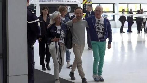 Frenchman Louis Arnaud is surrounded by his parents after his arrival at Le Bourget airport on 13 June, 2024.