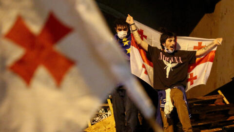 A protester carries a Georgian flag during a rally to protest against a bill on "foreign agents" in Tbilisi, Georgia, May 2, 2024.