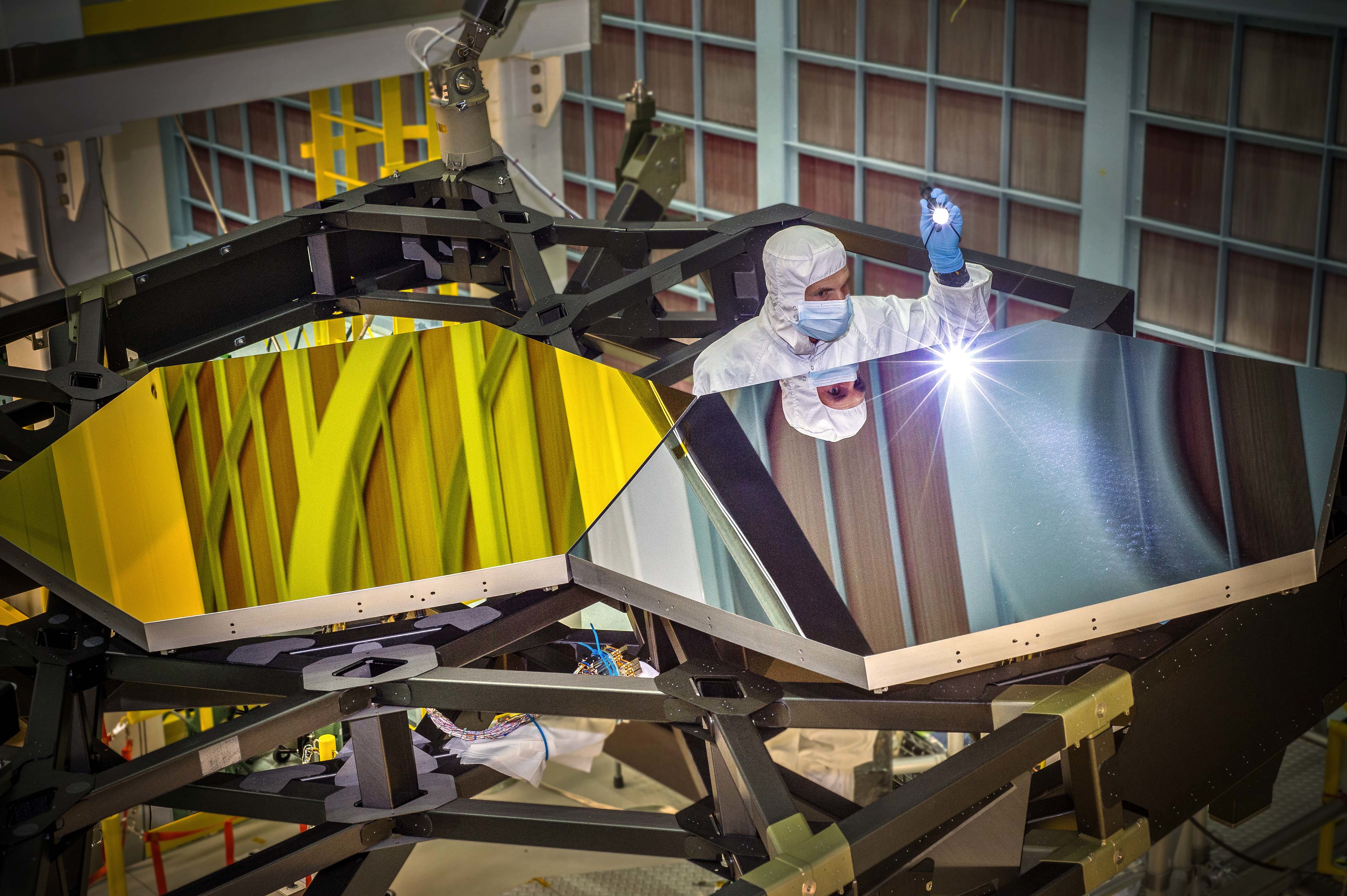 Engineer Larkin Carey examines two test mirror segments