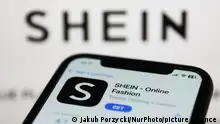 Shein on App Store displayed on a phone screen and Shein website displayed on a screen in the background are seen in this illustration photo taken in Krakow, Poland on January 19, 2023. (Photo by Jakub Porzycki/NurPhoto)