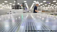 A worker at a workshop of a new energy company produces solar photovoltaic modules for export overseas in Lianyungang city, Jiangsu province, China, August 28, 2023. At present, locally produced solar photovoltaic modules are exported to India, Brazil, Japan, Europe and other countries. (Photo by Costfoto/NurPhoto)