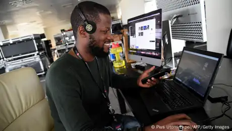 A journalist sits in front of a computer