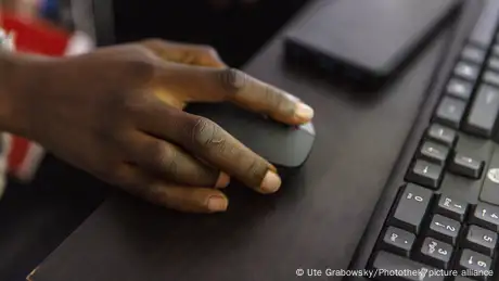 A hand on a computer mouse