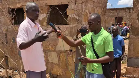 A Pwani FM reporter speaks to someone on location