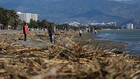 People walk along the beach after storm Gloria battered Spain's eastern coast in Torremolinos, Spain in 2020. 