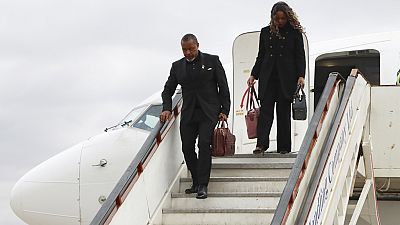 Malawi Vice President Saulos Chilima,left, and his wife Mary disembark from a plane upon his return from South Korea in Lillongwe, Sunday, June 9, 2024. 