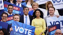 UK's Conservative Prime Minister and his wife Akshata Murty pose with supporters upon arrival to launch his party's manifesto