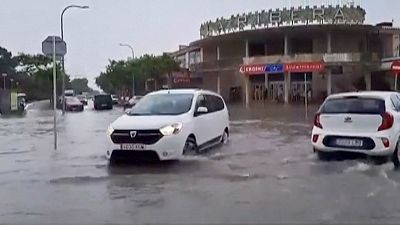 Cars driving through flooded traffic junction 