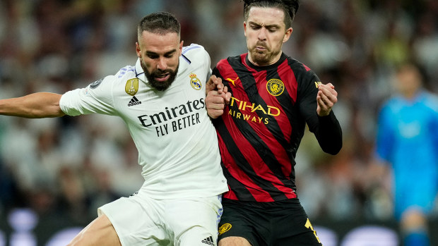 Real Madrid's Dani Carvajal, left, duels for the ball with Manchester City's Jack Grealish.