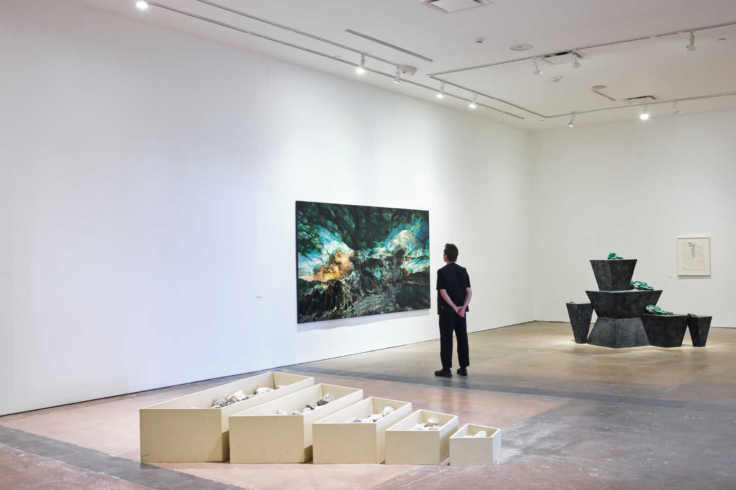 Robert Smithson and Teresita Fernández share billing at Site Santa Fe, a survey in New Mexico. From left, Smithson’s “A Nonsite (Franklin, New Jersey),” 1968; Fernández, “Viñales (Plateau),” 2019; Fernández, “Viñales (Reclining Nude),” 2015; and Smithson, “Road to Crater,” 1969.