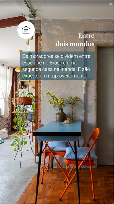 Interior of a home with a blue desk, organge chairs and plants 