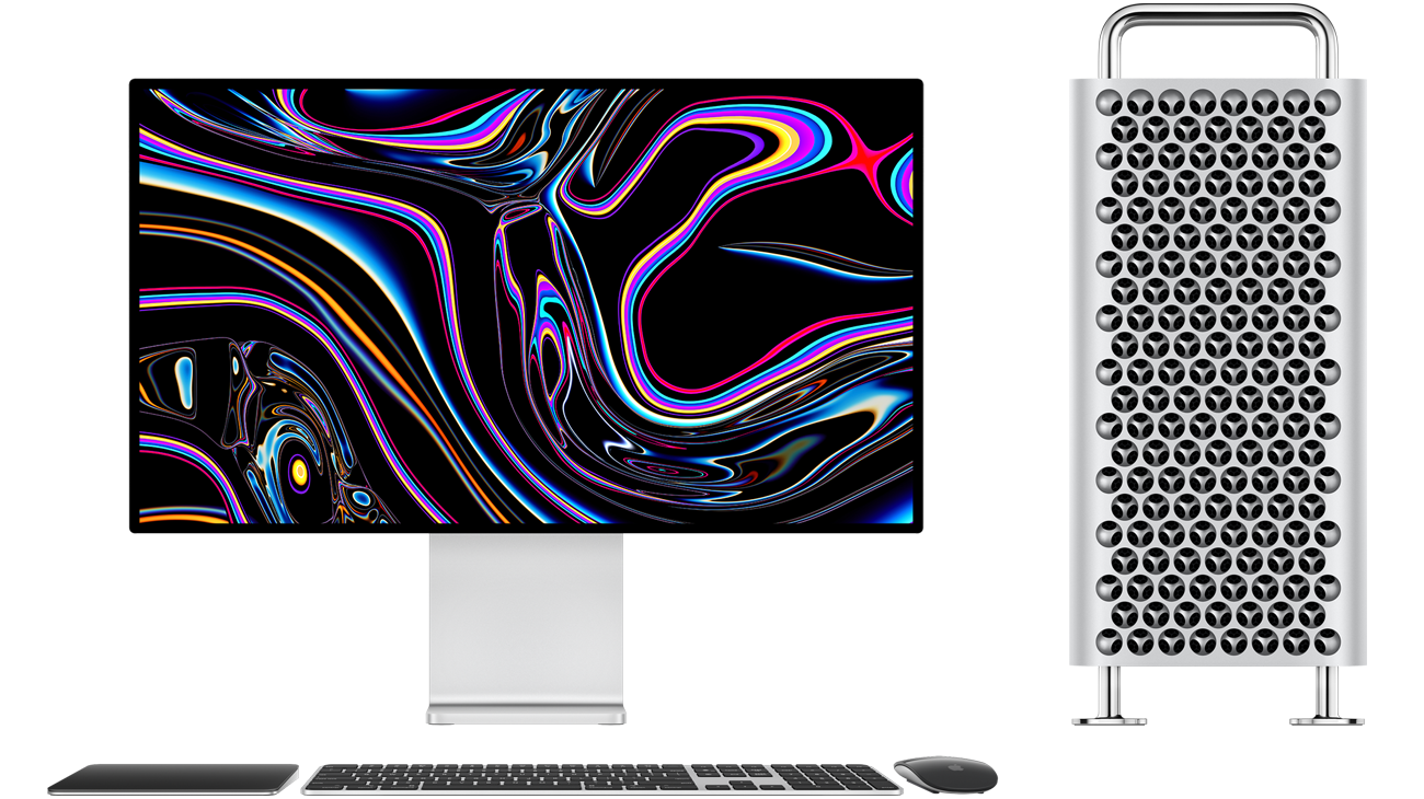 Mac Pro tower next to Pro Display XDR, black and silver Magic Trackpad, black and silver Magic Keyboard with Touch ID and Numeric Keypad, black and silver Magic Mouse