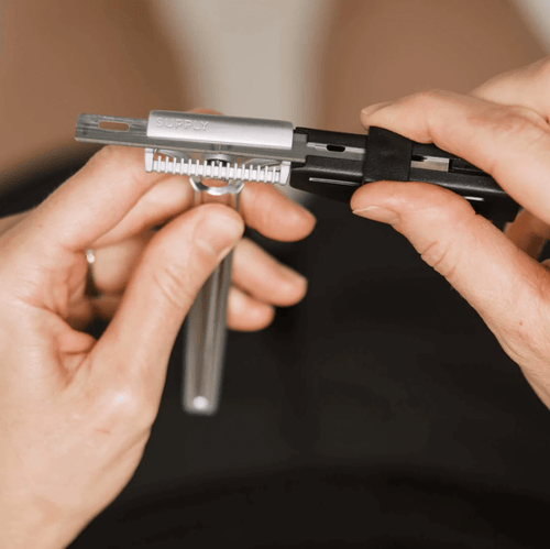 Pair of hands reloading the supply Black label blades